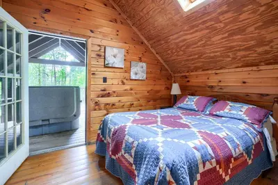 a bedroom with a bed in a wooden cabin at Blue Rose Cabins - Country Cottage in Logan