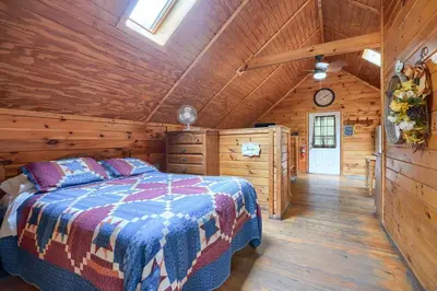 a bedroom with a bed in a wooden cabin at Blue Rose Cabins - Country Cottage in Logan
