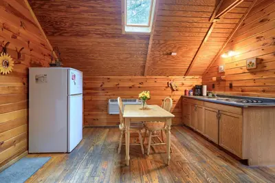a kitchen with a white refrigerator and a table at Blue Rose Cabins - Country Cottage in Logan