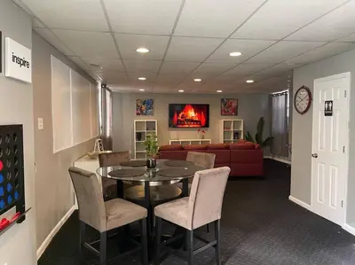 a living room with a table and chairs and a couch at Charming Urban Retreat - Near UC, Med Centers, OTR in Cincinnati