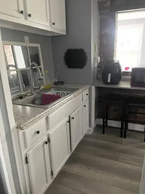 a kitchen with white cabinets and a sink at Charming Urban Retreat - Near UC, Med Centers, OTR in Cincinnati