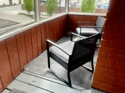 two chairs sitting on a balcony with a window at Charming Urban Retreat - Near UC, Med Centers, OTR in Cincinnati
