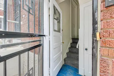 a door leading to a staircase with a brick wall at Pet-Friendly Cincinnati Apt 5 Mi to Downtown! in Cincinnati