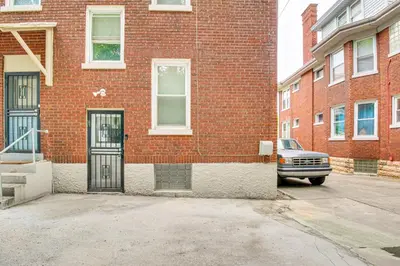 a brick building with a car parked in front of it at Pet-Friendly Cincinnati Apt 5 Mi to Downtown! in Cincinnati