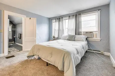 a bedroom with a large bed with a window at Pet-Friendly Cincinnati Apt 5 Mi to Downtown! in Cincinnati