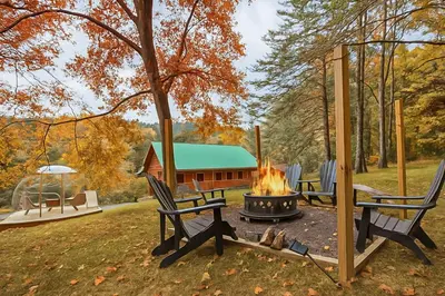 a fire pit in a yard with chairs and a cabin at Spring cabin with Dome, Sauna, Hot Tub, Pickleball, Firepit in Logan