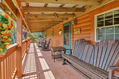 a porch with wooden benches on a house at Spring cabin with Dome, Sauna, Hot Tub, Pickleball, Firepit in Logan