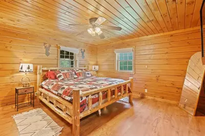 a bedroom with a bed in a log cabin at Spring cabin with Dome, Sauna, Hot Tub, Pickleball, Firepit in Logan