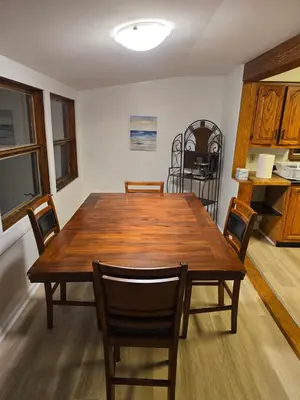 a dining room with a wooden table and chairs at Unit 2 at Oilgate at Oakdale in Akron
