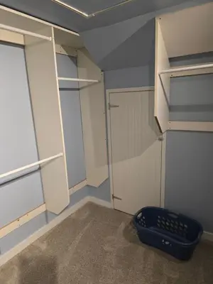 a walk in closet with a blue wall at Unit 2 at Oilgate at Oakdale in Akron