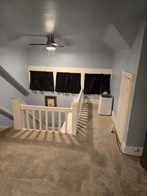 a baby room with a crib and a window at Unit 2 at Oilgate at Oakdale in Akron