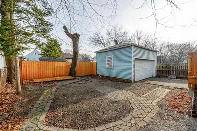 a blue shed in a yard next to a fence at Unit 2 at Oilgate at Oakdale in Akron