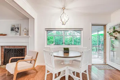 a dining room with a table and chairs and a fireplace at Thornville Home with Boat Dock On the Lake! in Hebron