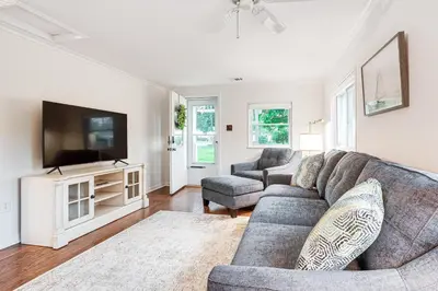 a living room with a couch and a flat screen tv at Thornville Home with Boat Dock On the Lake! in Hebron