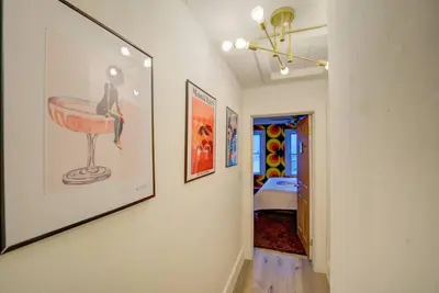 a hallway with paintings on the walls of a room at Retro 1970's Rollercoaster House 5 Mins from Cedar Point in Sandusky