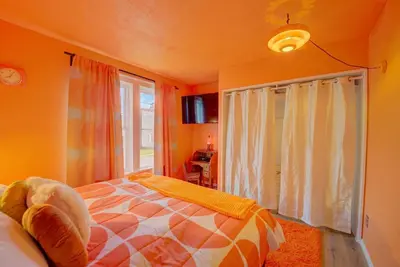 a bedroom with a bed and a large window at Retro 1970's Rollercoaster House 5 Mins from Cedar Point in Sandusky