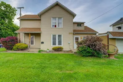 a house with a green lawn in front of it at Retro 1970's Rollercoaster House 5 Mins from Cedar Point in Sandusky