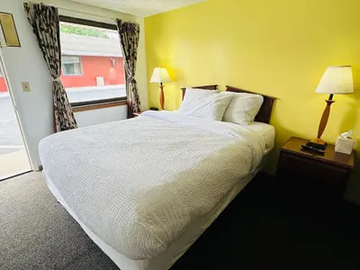 a bedroom with a large bed and a window at Quality Lodge in Sandusky