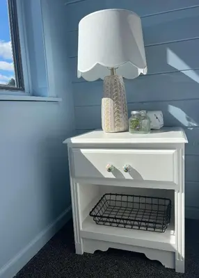 a white table with a lamp on top of it at Quality Lodge in Sandusky