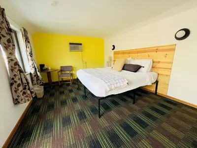 a bedroom with a large bed and a desk at Quality Lodge in Sandusky