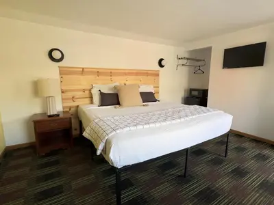a bedroom with a large bed and a flat screen tv at Quality Lodge in Sandusky
