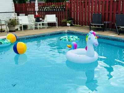 a pool with a unicorn float and other toys in it at Quality Lodge in Sandusky