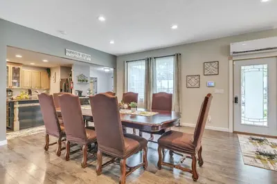 a kitchen and dining room with a table and chairs at Four-Bedroom House in Lapel