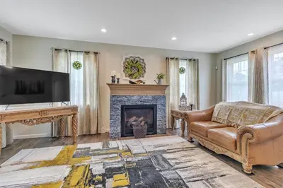 a living room with a couch and a fireplace at Four-Bedroom House in Lapel