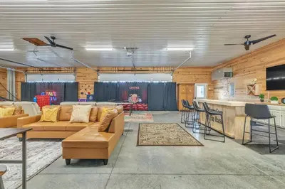 a living room with a couch and a bar at Four-Bedroom House in Lapel
