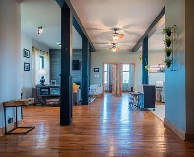 a large living room with wooden floors and blue walls at River City Loft in Portsmouth