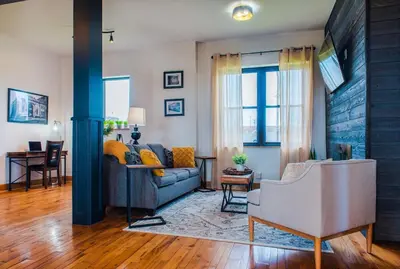 a living room with a couch and a table at River City Loft in Portsmouth