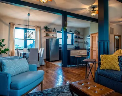 a living room with a blue couch and a kitchen at River City Loft in Portsmouth