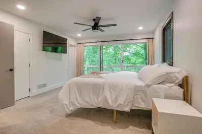 a bedroom with a bed and a ceiling fan at Spacious Riverfront Delaware Home with Views in Delaware