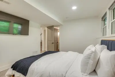 a white bedroom with a bed with white sheets and pillows at Spacious Riverfront Delaware Home with Views in Delaware