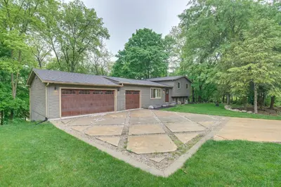 a house with a garage and a driveway at Spacious Riverfront Delaware Home with Views in Delaware