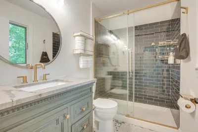a bathroom with a toilet and a sink and a shower at Spacious Riverfront Delaware Home with Views in Delaware