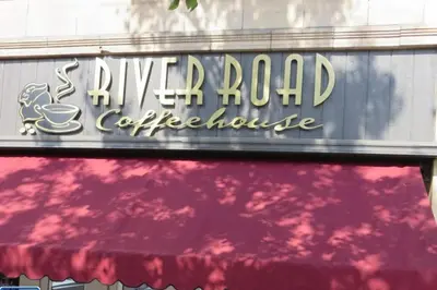 a sign for a river road coffee house at Unique and Charming Downtown Apt in Newark
