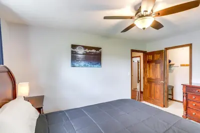 a bedroom with a bed and a ceiling fan at Port Clinton Home Hot Tub, Steps to Portage River in Port Clinton