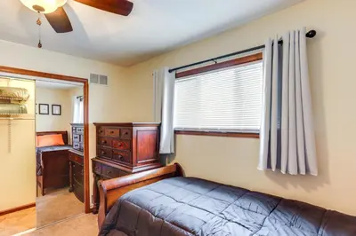a bedroom with a bed and a dresser and a window at Port Clinton Home Hot Tub, Steps to Portage River in Port Clinton