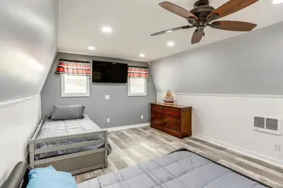 a bedroom with a bed and a ceiling fan at Port Clinton Home Hot Tub, Steps to Portage River in Port Clinton