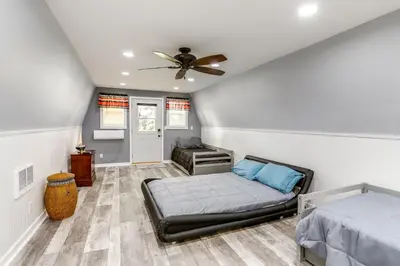 a bedroom with a bed and a ceiling fan at Port Clinton Home Hot Tub, Steps to Portage River in Port Clinton