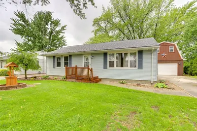 a small blue house with a yard at Port Clinton Home Hot Tub, Steps to Portage River in Port Clinton