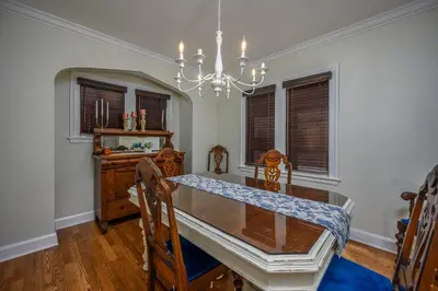 a dining room with a table and chairs and a chandelier at Rachel's Private Hideaway with king bed, kitchen, laundry, parking and big yard in Toledo