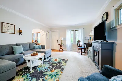 a living room with a couch and a tv at Rachel's Private Hideaway with king bed, kitchen, laundry, parking and big yard in Toledo