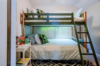 a bunk bed in a room with a bunk bed in a dorm room at Rachel's Private Hideaway with king bed, kitchen, laundry, parking and big yard in Toledo