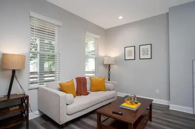 a living room with a couch and a table at Beautiful 4 Bedroom House Near Downtown Columbus with Garage Parking and Backyard in Columbus