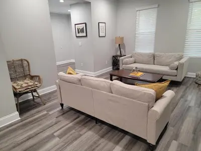 a living room with two couches and a table at Beautiful 4 Bedroom House Near Downtown Columbus with Garage Parking and Backyard in Columbus