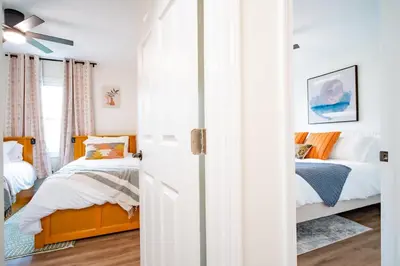 a bedroom with two beds and a ceiling fan at Lake Erie BreezeYour Restful Vermilion 3BR Vacation Home close to Cedar Point in Vermilion