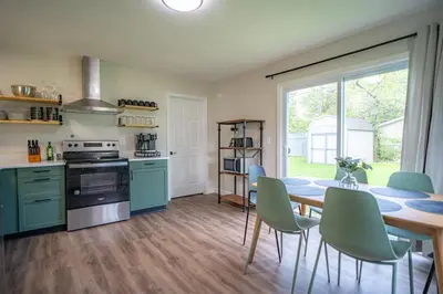 a kitchen and dining room with a table and chairs at Lake Erie BreezeYour Restful Vermilion 3BR Vacation Home close to Cedar Point in Vermilion