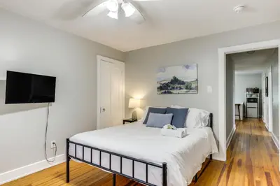 a bedroom with a bed and a flat screen tv at Cincinnati Apartment 1 Mi to Hyde Park Square! in Cincinnati
